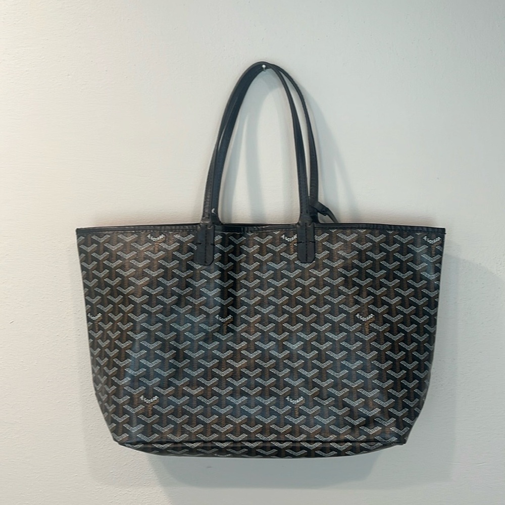 Black patterned tote with small pouch.